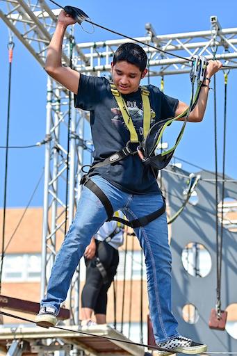 Student on a ropes course outside